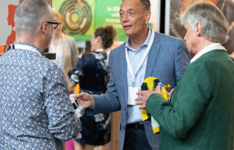 Exhibitors Edwin Maes (Centexbel) and John Beelen (Wear2Go) and a visitor in a conversion