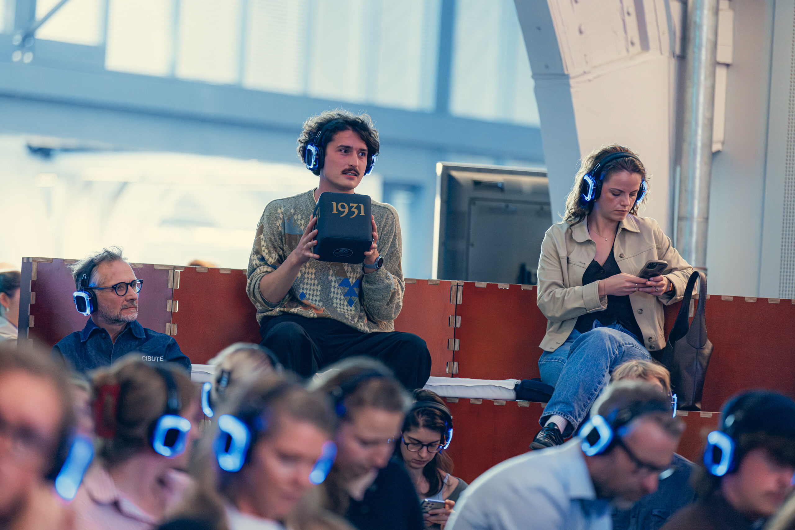 Visitors attending Circular Textile Days wearing silent conference headsets during industry presentations.